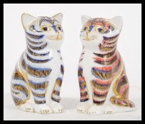 Two Crown Derby Imari ceramic paperweights in the form of cats, one having blue colouration and