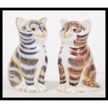 Two Crown Derby Imari ceramic paperweights in the form of cats, one having blue colouration and