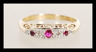 An 18ct gold stamped diamond and garnet stone ring