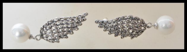 A pair of stamped 925 silver earrings in the form