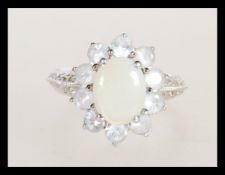 A hallmarked 9ct white gold opal and white stone c