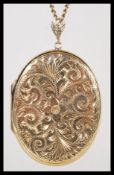 A hallmarked 9ct gold large locket pendant of oval