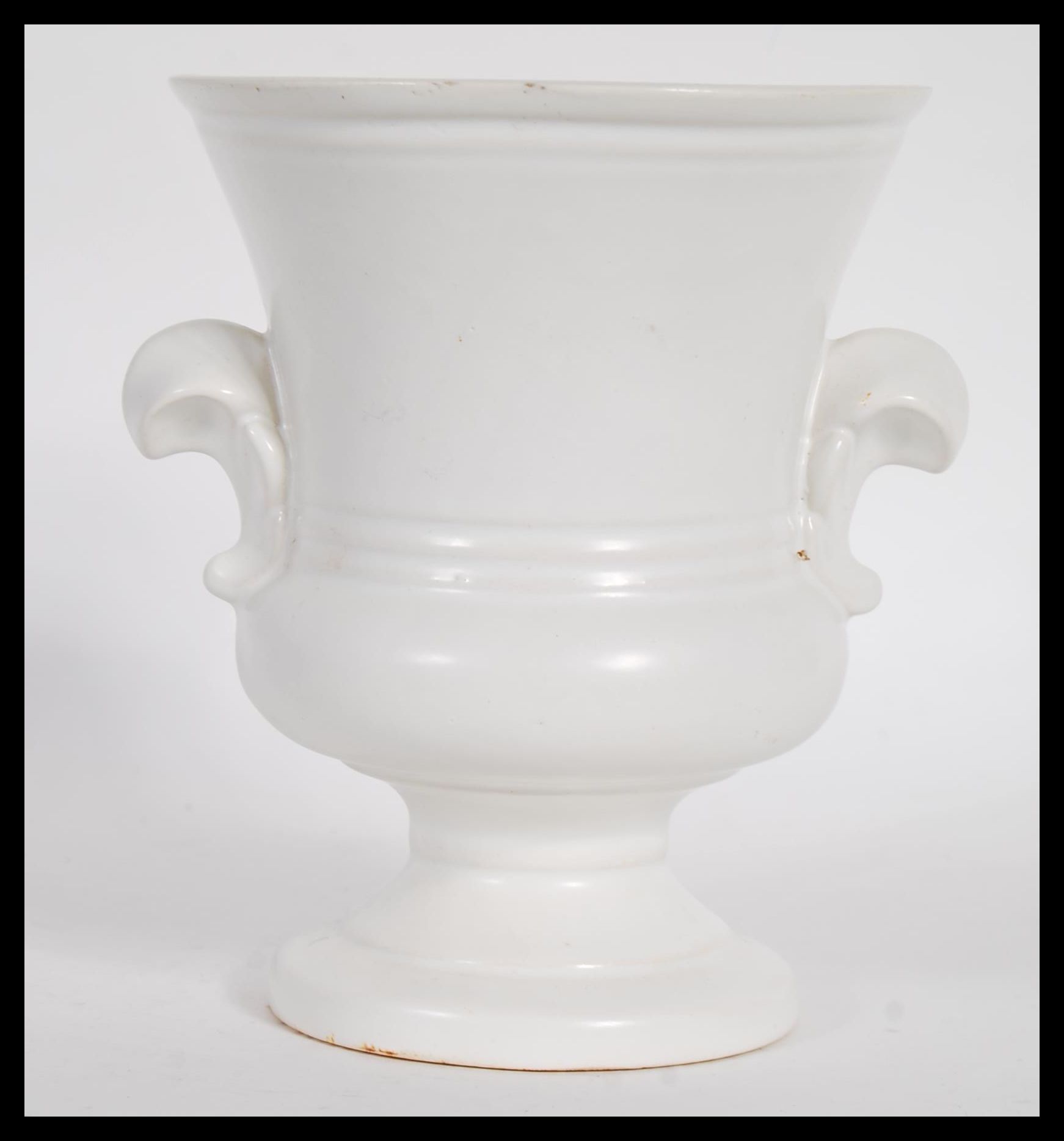 A vintage 20th century cream glazed pottery plant