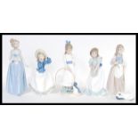 A collection of five Nao porcelain figurines to in