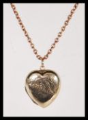 A 20th Century stamped 9ct gold heart locket havin