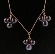 An early 20th century 9ct gold and amethyst pendant necklace. The necklace having three amethyst