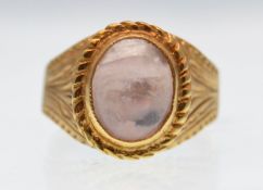 A modern 18ct gold and rose quartz cabochon ring