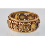 An unusual early 20th century continental gold citrine and rose diamond broad band ring. The oval