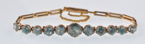 A vintage 9ct gold and blue zircon bracelet. The eleven graduated round zircons all being claw set