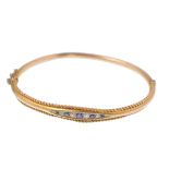 A 19th Century Victorian 15ct gold diamond and sapphire bangle bracelet. The bracelet having a group