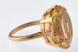 A vintage 9ct gold and large oval citrine single stone ring. Stamped 9ct. Weight 6.8g