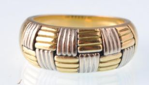 A modern Italian bi-colour gold tapering chequer board ring. Italian marks, stamped 750. Weight 10g