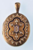 A Victorian gold half pearl and enamel oval locket.  Decorated with an enamel border with hexafoil