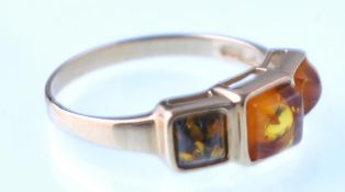 A 9ct gold and square cabochon amber 3 stone ring. Post 2000 hallmarks. Weight 2.3g