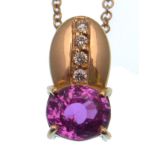 A pink sapphire and diamond pendant, the oval ston