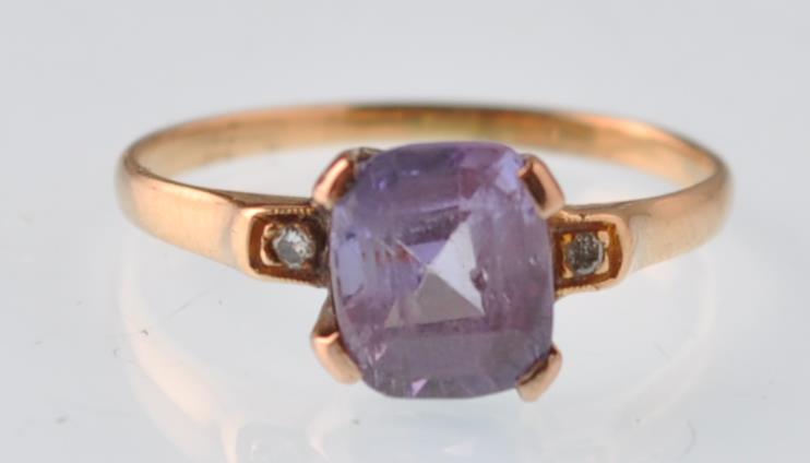 An 18ct gold purple sapphire and diamond dress ring. The violet cushion shaped stone being claw - Image 2 of 4