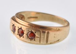 A modern 9ct gold and round garnet 3 stone gypsy ring. Weight 3.7g