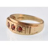 A modern 9ct gold and round garnet 3 stone gypsy ring. Weight 3.7g