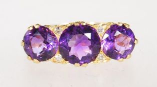 A HALLMARKED 18CT GOLD AMETHYST AND DIAMOND RING