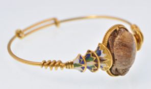 A yellow gold Egyptian revival and enamel scarab bracelet bangle. The bracelet decorated with