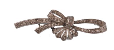 An early 20th century 18ct gold and diamond brooch. The brooch in the form of a bow and spray,