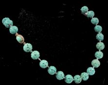 An early 20th century French carved turquoise colour bead necklace. The beads carved depicting