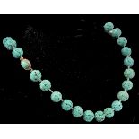 An early 20th century French carved turquoise colour bead necklace. The beads carved depicting