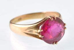 An early 20th century gold and synthetic ruby? single stone ring being stamped 18ct. Weight 3.7g