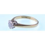 A modern 18ct gold and diamond solitaire ring. The round brilliant illusion set in round and yellow.