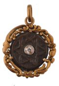 A 19th century gold and diamond pendant. The pendant having a gold scrolled foliate mount with