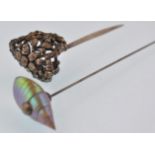 An early 20th century hat pin and hair stick pin. The hat pin completed with a shell finial, the