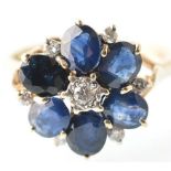 A 9CT GOLD SAPPHIRE AND DIAMOND LADIES FLOWER HEAD RING