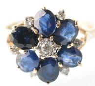 A 9CT GOLD SAPPHIRE AND DIAMOND LADIES FLOWER HEAD RING