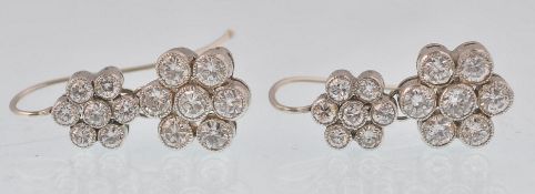 A pair of 18ct white gold and diamond earrings. The earrings consisting of double cluster