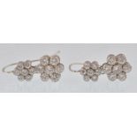 A pair of 18ct white gold and diamond earrings. The earrings consisting of double cluster