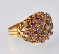 A modern Italian 18ct gold gold emerald, sapphire, ruby and diamond bombe cluster ring. Stamped 18k.