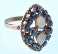 A modern 14ct opal and sapphire marquise shaped cluster ring. Set with pear shaped opals and 16