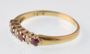 An 18ct gold ruby and diamond seven stone ring. Hallmarks for Birmingham 1993. Weight 2.0g
