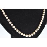 A pearl sapphire and diamond matinee necklace. The necklace consisting of a string of graduated