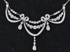 An 18ct gold and diamond Belle Époque diamond swag necklace. The necklace designed as three