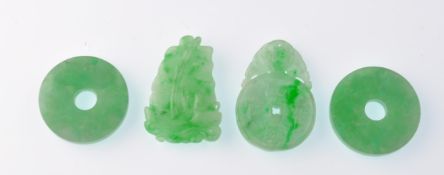 A collection of 4 Jadeite Chinese pendants, one being drop shaped with the form of a tall sailing