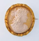 A Victorian gold and oval shell cameo brooch depicting Ceres in high relief within a gold oak leaf