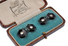 A pair of  Art Deco French platinum, onyx and diamond cufflinks. The cufflinks of hexagonal form