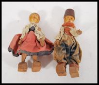 Two vintage retro wooden dolls in the form of an A