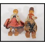 Two vintage retro wooden dolls in the form of an A