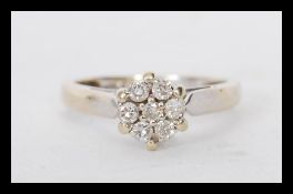 A hallmarked 18ct gold diamond cluster ring having