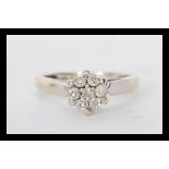 A hallmarked 18ct gold diamond cluster ring having