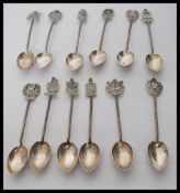 A collection of silver souvenir tea spoons having