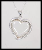A stamped 925 silver pendant necklace having a hea