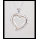 A stamped 925 silver pendant necklace having a hea